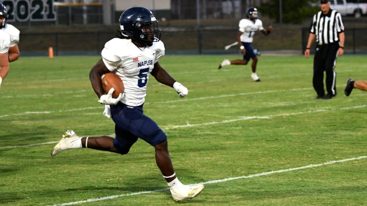 Naples Golden Eagles running back Shawn Simeon (#5) is hard to stop. Spring football was back as Venice hosted the Naples Golden Eagles at Venice's Powell-Davis Stadium Tuesday evening May 21, 2024. Venice went on to win 27-17.