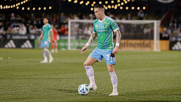 Apr 26, 2025; Commerce City, Colorado, USA; Seattle Sounders forward Ryan Kent (77) controls the ball as Colorado Rapids midfielder Cole Bassett (23) defends in the second half at Dick's Sporting Goods Park. Mandatory Credit: Isaiah J. Downing-Imagn Images