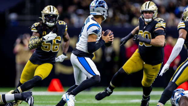 Panthers quarterback Bryce Young (9) is pressured by Saints linebacker Demario Davis (56) and defensive tackle Bryan Bresee 