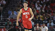 Nov 16, 2025; Houston, Texas, USA; Houston Rockets guard Reed Sheppard (15) smiles after a play during the second quarter against the Orlando Magic at Toyota Center. Mandatory Credit: Troy Taormina-Imagn Images