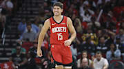 Nov 16, 2025; Houston, Texas, USA; Houston Rockets guard Reed Sheppard (15) smiles after a play during the second quarter against the Orlando Magic at Toyota Center. Mandatory Credit: Troy Taormina-Imagn Images
