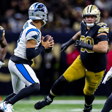 Panthers quarterback Bryce Young (9) is pressured by New Orleans Saints linebacker Demario Davis (56) and defensive tackle Bryan Bresee (90)