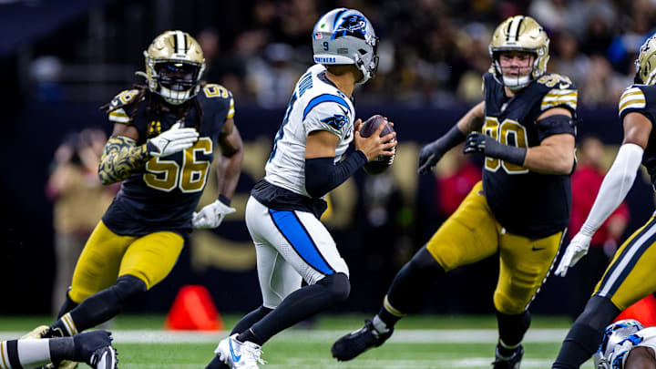 Panthers quarterback Bryce Young (9) is pressured by New Orleans Saints linebacker Demario Davis (56) and defensive tackle Bryan Bresee (90)