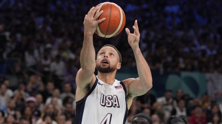 Jul 31, 2024; Villeneuve-d'Ascq, France; United States shooting guard Stephen Curry (4) drives against South Sudan point guard Marial Shayok (11) in the fourth quarter during the Paris 2024 Olympic Summer Games at Stade Pierre-Mauroy. Mandatory Credit: John David Mercer-USA TODAY Sports