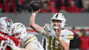 Nov 1, 2025; Raleigh, North Carolina, USA;  Georgia Tech Yellow Jackets quarterback Haynes King (10) throws a pass in the fourth quarter against the NC State Wolfpack at Carter-Finley Stadium. Mandatory Credit: Zachary Taft-Imagn Images