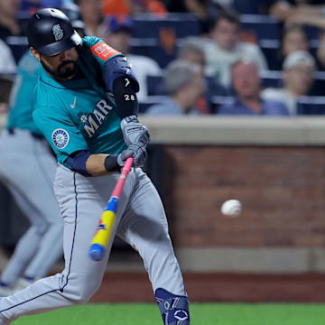 Aug 15, 2025; New York City, New York, USA; Seattle Mariners third baseman Eugenio Suarez (28) hits an RBI double against the New York Mets during the seventh inning at Citi Field. Mandatory Credit: Brad Penner-Imagn Images