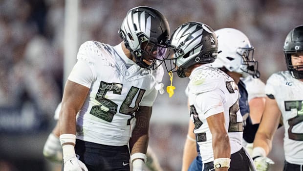 Oregon inside linebacker Jerry Mixon, left and Oregon defensive back Jadon Canady celebrate as the Oregon Ducks face the Penn
