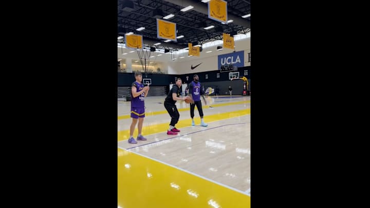 Luka Doncic shoots next to LeBron James and Austin Reaves