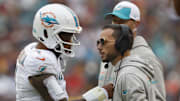 Miami Dolphins coach Mike McDaniel speaks with Tua Tagovailoa during a timeout in a December 2023 game. 