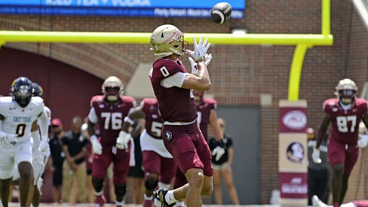 Sep 6, 2025; Tallahassee, Florida, USA; Florida State Seminoles wide receiver Duce Robinson (0) catches a touchdown during the first half against the East Texas A&M at Doak S. Campbell Stadium. Mandatory Credit: Melina Myers-Imagn Images