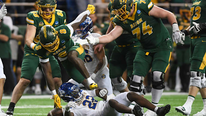 North Dakota State Bison running back Barika Kpeenu (8) trips over South Dakota State Jackrabbits cornerback Colby Humphrey (22) on Saturday, Dec. 21, 2024, at Fargodome in Fargo, Nouth Dakota.