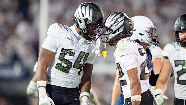 Oregon inside linebacker Jerry Mixon, left and Oregon defensive back Jadon Canady celebrate as the Oregon Ducks face the Penn State Nittany Lions on Sept. 27, 2025, at Beaver Stadium in University Park, Pennsylvania.