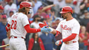 Mar 31, 2025; Philadelphia, Pennsylvania, USA; Philadelphia Phillies designated hitter Kyle Schwarber (12) celebrates his two-run home run with third base Alec Bohm (28) during the seventh inning against the Colorado Rockies at Citizens Bank Park. Mandatory Credit: Eric Hartline-Imagn Images