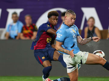 Jul 30, 2024; Orlando, FL, USA; Manchester City midfielder Kalvin Phillips (4) blocks a cross from Barcelona defender Alejandro Balde (3).