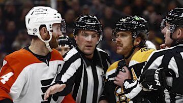 Dec 7, 2024; Boston, Massachusetts, USA; The linesman gets between Philadelphia Flyers center Sean Couturier (14) and Boston Bruins right wing David Pastrnak (88) during the second period at TD Garden. Mandatory Credit: Winslow Townson-Imagn Images