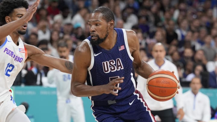 Aug 3, 2024; Villeneuve-d'Ascq, France; United States guard Kevin Durant (7) dribbles against Puerto Rico forward Aleem Ford (12) in the second quarter during the Paris 2024 Olympic Summer Games at Stade Pierre-Mauroy. Mandatory Credit: John David Mercer-USA TODAY Sports