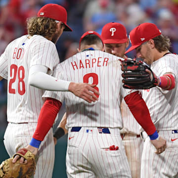 Jun 30, 2025; Philadelphia, Pennsylvania, USA; Philadelphia Phillies third base Alec Bohm (28), first base Bryce Harper (3), shortstop Trea Turner (7) and second base Bryson Stott (5) celebrate win against the San Diego Padres at Citizens Bank Park.