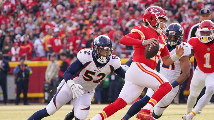 Jan 1, 2023; Kansas City, Missouri, USA; Kansas City Chiefs quarterback Patrick Mahomes (15) runs the ball as Denver Broncos linebacker Wyatt Ray (52) defends during the first half at GEHA Field at Arrowhead Stadium.