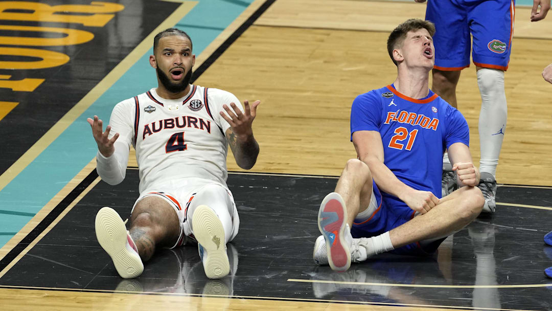 Apr 5, 2025; San Antonio, TX, USA; Auburn Tigers forward Johni Broome (4) reacts after being fouled by Florida Gators forward Alex Condon (21) during the second half in the semifinals of the men's Final Four of the 2025 NCAA Tournament at Alamodome. Mandatory Credit: Scott Wachter-Imagn Images

