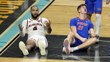 Apr 5, 2025; San Antonio, TX, USA; Auburn Tigers forward Johni Broome (4) reacts after being fouled by Florida Gators forward Alex Condon (21) during the second half in the semifinals of the men's Final Four of the 2025 NCAA Tournament at Alamodome. Mandatory Credit: Scott Wachter-Imagn Images

