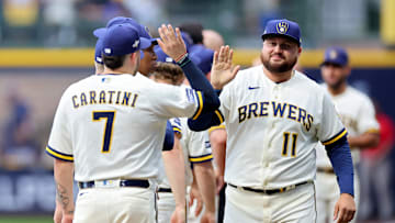 Rowdy Tellez and Victor Caratini high-five after the Wild Card Series - Arizona Diamondbacks v Milwaukee Brewers - Game One.