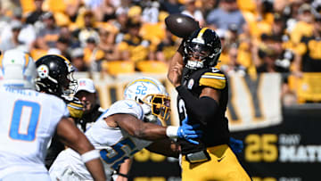 Sep 22, 2024; Pittsburgh, Pennsylvania, USA; Pittsburgh Steelers quarterback Justin Fields (2) throws a pass while under pressure from Los Angeles Chargers linebacker Khalil Mack (52) during the second quarter at Acrisure Stadium. Mandatory Credit: Barry Reeger-Imagn Images
