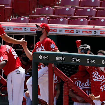 Cincinnati Reds starting pitcher Trevor Bauer (27) is congratulated as he leaves the game with 13 strikeouts in the seventh inning of the MLB interleague game between the Cincinnati Reds and the Detroit Tigers at Great American Ball Park in downtown Cincinnati on Sunday, July 26, 2020. 