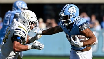Oct 12, 2024; Chapel Hill, North Carolina, USA;  North Carolina Tar Heels running back Omarion Hampton (28) with the ball as Georgia Tech Yellow Jackets linebacker Kyle Efford (44) defends in the fourth quarter at Kenan Memorial Stadium. Mandatory Credit: Bob Donnan-Imagn Images