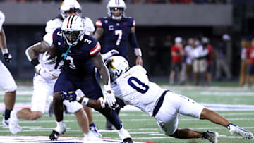 Sep 2, 2023; Tucson, Arizona, USA; Arizona Wildcats running back Jonah Coleman (3) sheds a tackle agaisnt Northern Arizona Lumberjacks running back Chase Belcher (0) during the second half at Arizona Stadium. Mandatory Credit: Zac BonDurant-USA TODAY Sports