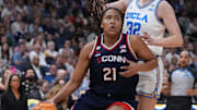 Connecticut Huskies forward Sarah Strong (21) dribbles against UCLA Bruins forward Angela Dugalic (32) during first quarter in a semifinal of the women's 2025 NCAA tournament at Amalie Arena. Mandatory Credit: Kirby Lee-Imagn Images