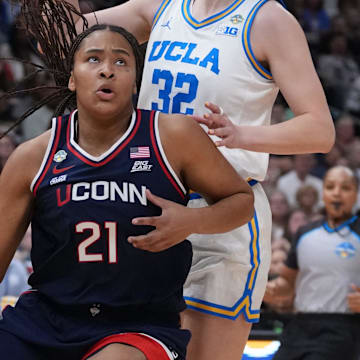 Connecticut Huskies forward Sarah Strong (21) dribbles against UCLA Bruins forward Angela Dugalic (32) during first quarter in a semifinal of the women's 2025 NCAA tournament at Amalie Arena. Mandatory Credit: Kirby Lee-Imagn Images