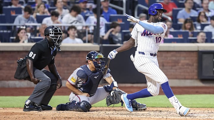 Jun 25, 2025; New York City, New York, USA; New York Mets second baseman Ronny Mauricio (10) hits a single in the fourth inning against the Atlanta Braves at Citi Field. Mandatory Credit: Wendell Cruz-Imagn Images