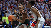 Dec 2, 2025; Oxford, Mississippi, USA; Miami Hurricanes forward Shelton Henderson (7) drives to the basket as Mississippi Rebels forward Augusto Cassiá (88) defends during the first half at The Sandy and John Black Pavilion at Ole Miss. Mandatory Credit: Petre Thomas-Imagn Images