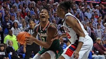 Dec 2, 2025; Oxford, Mississippi, USA; Miami Hurricanes forward Shelton Henderson (7) drives to the basket as Mississippi Rebels forward Augusto Cassiá (88) defends during the first half at The Sandy and John Black Pavilion at Ole Miss. Mandatory Credit: Petre Thomas-Imagn Images