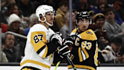 Nov 29, 2024; Boston, Massachusetts, USA; Captains, Pittsburgh Penguins center Sidney Crosby (87) and Boston Bruins left wing Brad Marchand (63) look back towards their benches as the referees sort out penalties against each team during the first period at TD Garden. Mandatory Credit: Winslow Townson-Imagn Images