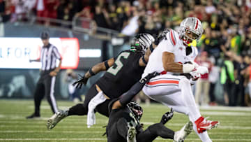 Oregon Ducks defensive back Brandon Johnson and Oregon Ducks defensive back Kobe Savage trip up Ohio State Buckeyes wide receiver Emeka Egbuka as the No. 3 Oregon Ducks host the No. 2 Ohio State Buckeyes Saturday, Oct. 12, 2024 at Autzen Stadium in Eugene, Ore.