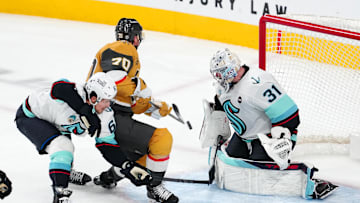Dec 21, 2024; Las Vegas, Nevada, USA; Seattle Kraken goaltender Philipp Grubauer (31) makes a save against Vegas Golden Knights left wing Tanner Pearson (70) as Seattle Kraken defenseman Brandon Montour (62) looks to break up the play during the third period at T-Mobile Arena. Mandatory Credit: Stephen R. Sylvanie-Imagn Images