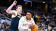 Mar 15, 2025; Indianapolis, IN, USA; Maryland Terrapins center Derik Queen (25) dribbles the ball while Michigan Wolverines center Danny Wolf (1) defends in the second half at Gainbridge Fieldhouse. Mandatory Credit: Trevor Ruszkowski-Imagn Images