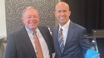 Jack Degele (left) poses with Our Lady of Mount Carmel basketball coach Tony Martin after Martin  was selected as the Baltimore Catholic League Coach of the Year at the league’s annual award luncheon in February. Degele has stepped down as the BCL commissioner after a successful 25-year run.