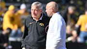 Oct 21, 2023; Iowa City, Iowa, USA; Iowa Hawkeyes head coach Kirk Ferentz and Minnesota Golden Gophers head coach P.J. Fleck talk before a game at Kinnick Stadium.
