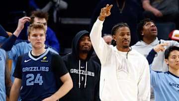 Nov 20, 2024; Memphis, Tennessee, USA; Memphis Grizzlies guards Cam Spencer (24), Marcus Smart (36) and Ja Morant (12) on the bench during the second half against the Philadelphia 76ers  at FedExForum. 