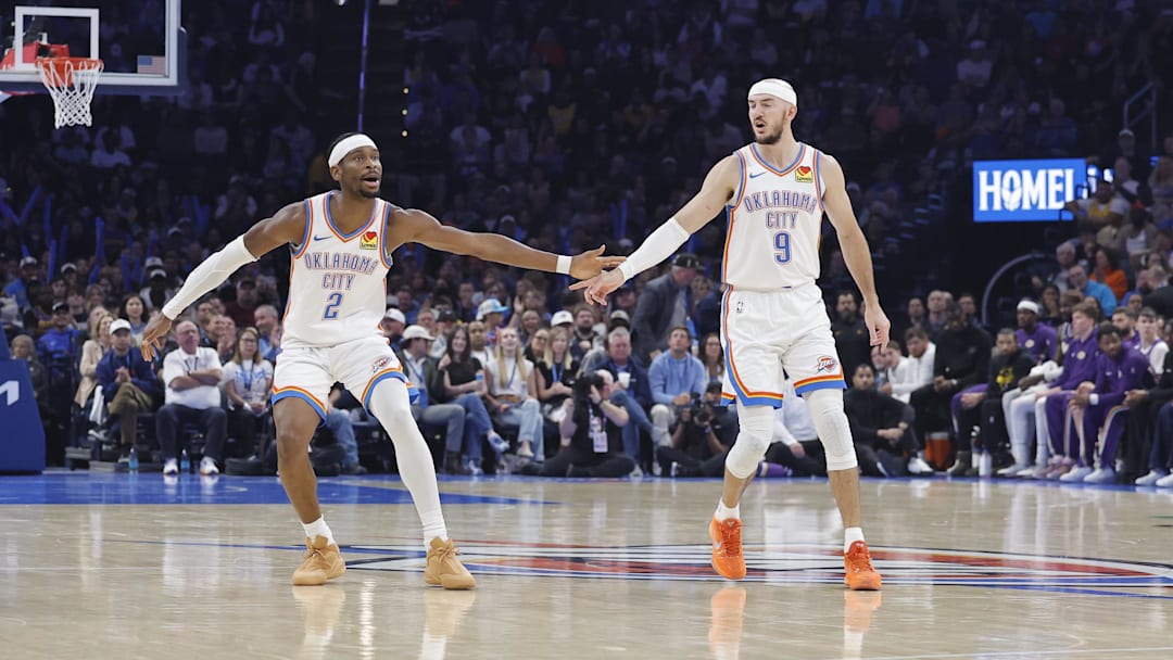 Nov 12, 2025; Oklahoma City, Oklahoma, USA; Oklahoma City Thunder guard Shai Gilgeous-Alexander (2) and Oklahoma City Thunder guard Alex Caruso (9) celebrate after a basket against the Los Angeles Lakers during the second quarter at Paycom Center. Mandatory Credit: Alonzo Adams-Imagn Images