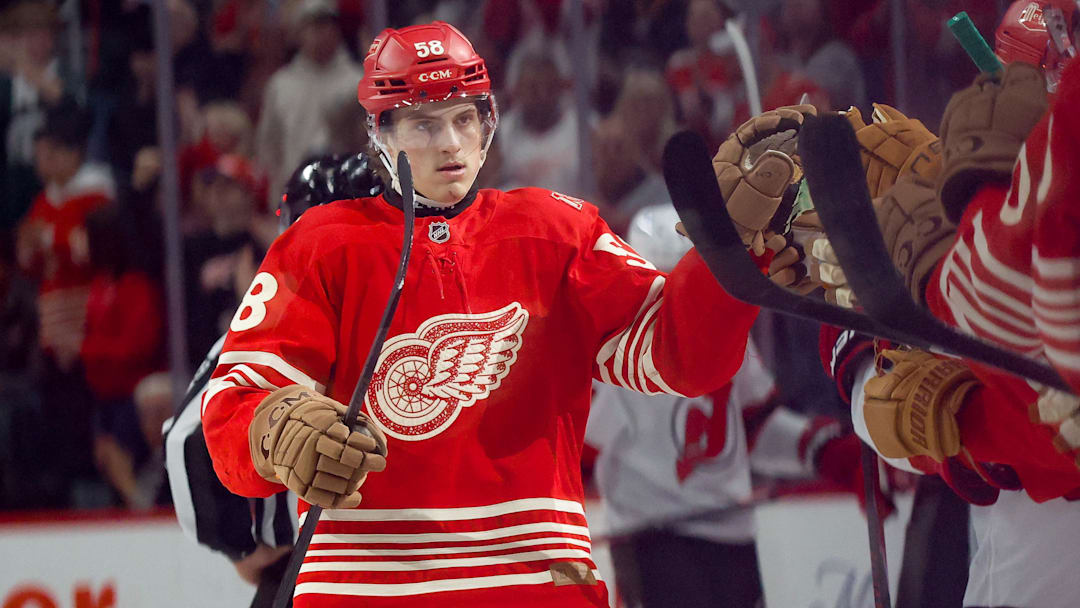 Apr 11, 2026; Detroit, Michigan, USA;  Detroit Red Wings center Emmitt Finnie (58) receives congratulations from teammates after scoring in the third period against the New Jersey Devils at Little Caesars Arena. Mandatory Credit: Rick Osentoski-Imagn Images