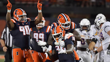 Aug 29, 2025; Champaign, Illinois, USA;  Illinois Fighting Illini linebacker Gabe Jacas (17) jumps on teammate Illinois Fighting Illini defensive lineman Eli Coenen (96) after a sack on Western Illinois Leathernecks quarterback Chris Irvin (5) during the first half at Memorial Stadium. Mandatory Credit: Ron Johnson-Imagn Images