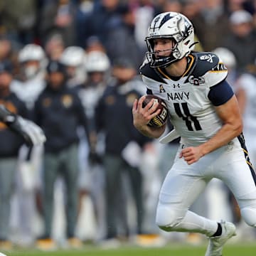 Navy Midshipmen quarterback Blake Horvath carries the ball against the Army Black Knights during the first half of the 125th Army-Navy game at Northwest Stadium on December 14, 2024. 