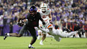 TCU Horned Frogs wide receiver Savion Williams (3) is tackled by Oklahoma State Cowboys safety Dylan Smith (11).