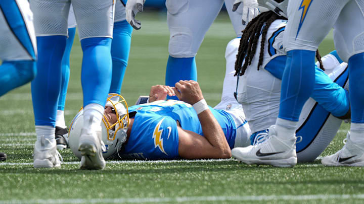 Sep 15, 2024; Charlotte, North Carolina, USA; Los Angeles Chargers quarterback Justin Herbert (10) is slow to get up after a hit against the Carolina Panthers during the second half at Bank of America Stadium. Mandatory Credit: Jim Dedmon-Imagn Images