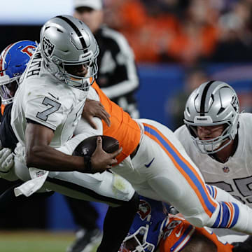 Nov 6, 2025; Denver, Colorado, USA; Las Vegas Raiders quarterback Geno Smith (7) is sacked for a loss against the Denver Broncos during the second half at Empower Field at Mile High. Mandatory Credit: Isaiah J. Downing-Imagn Images