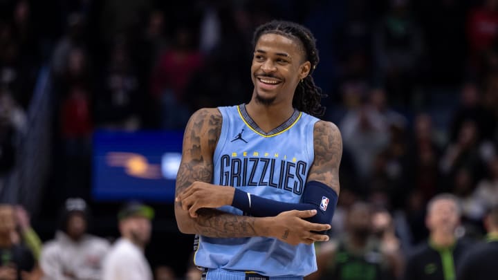 Dec 26, 2023; New Orleans, Louisiana, USA; Memphis Grizzlies guard Ja Morant (12) smiles at a fan as the end of regulation against the New Orleans Pelicans at Smoothie King Center. 