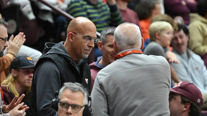 Dec 31, 2025; Blacksburg, Virginia, USA;   Virginia Tech head football coach James Franklin talks to a fan during the first half at Cassell Coliseum. Mandatory Credit: Brian Bishop-Imagn Images